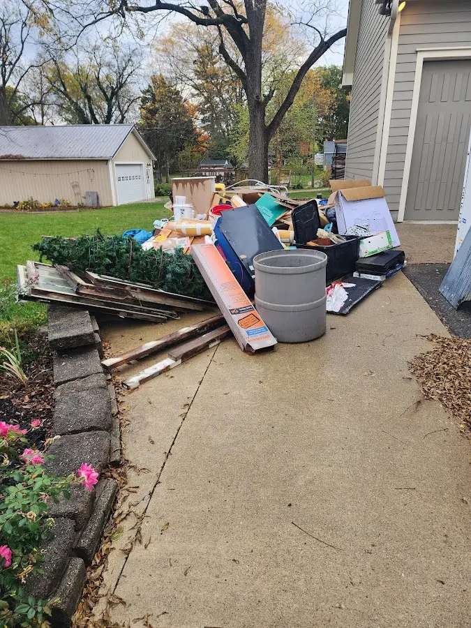 Dumpster being loaded with debris for Roofing Dumpster Rental in Maryville